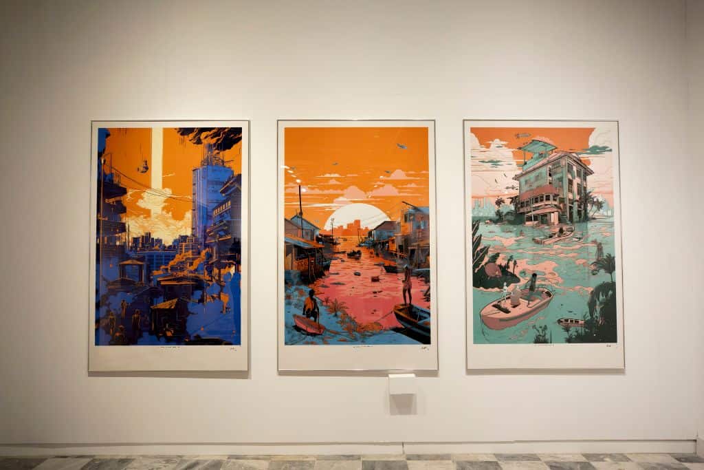 A row of three vibrantly colored rectangular paintings of city and coastal skylines.