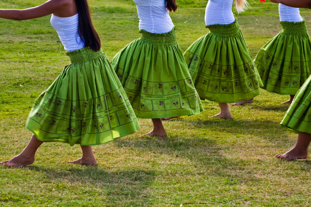 Hula dancers in green skirts and white shirts in Kauai