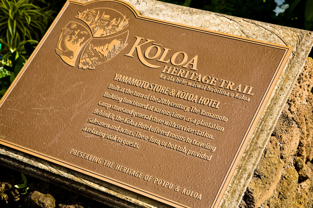 A sign that says Koloa Heritage Trail on it, explaining the significance