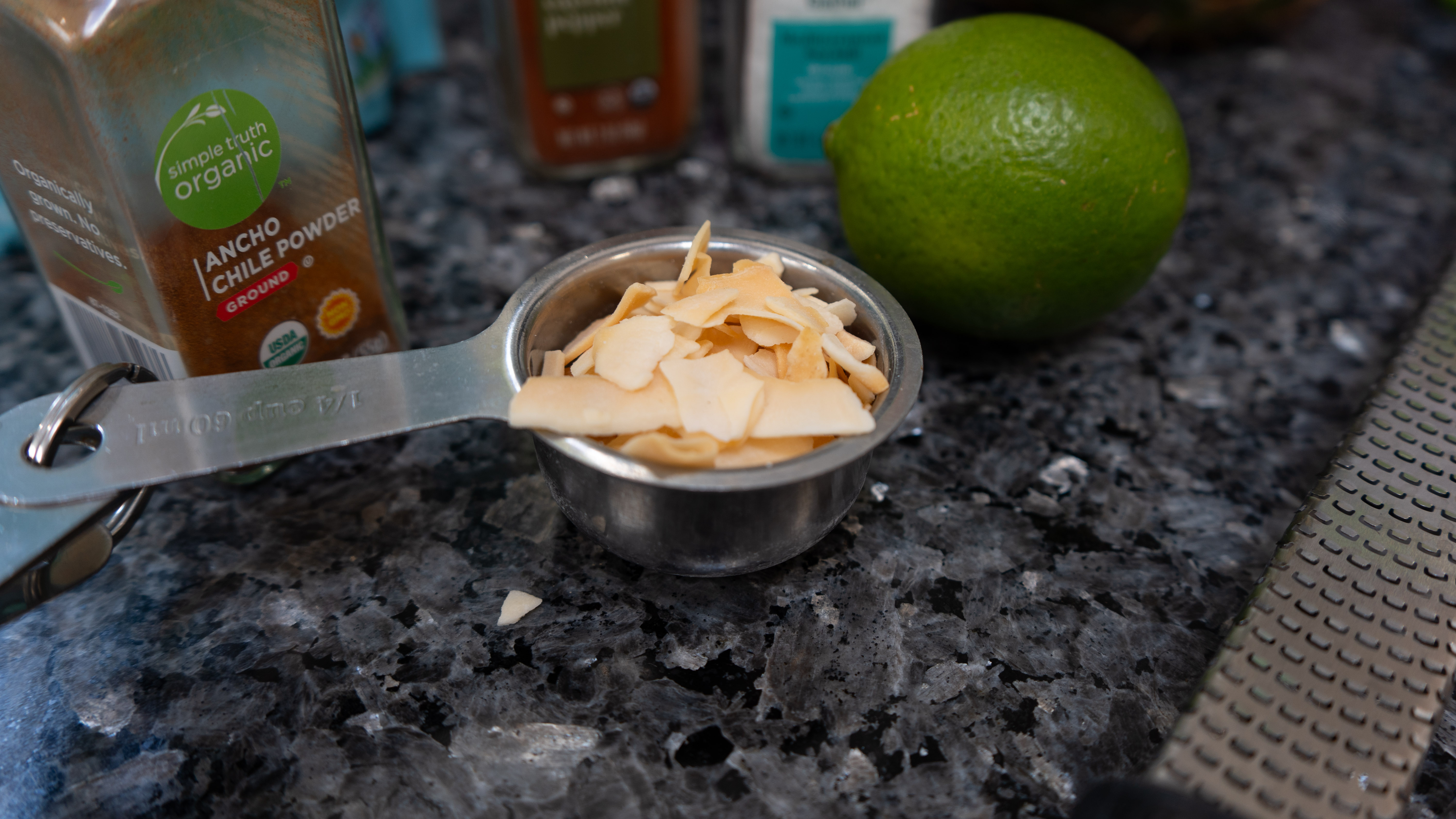 A measuring cup with coconut flakes in it