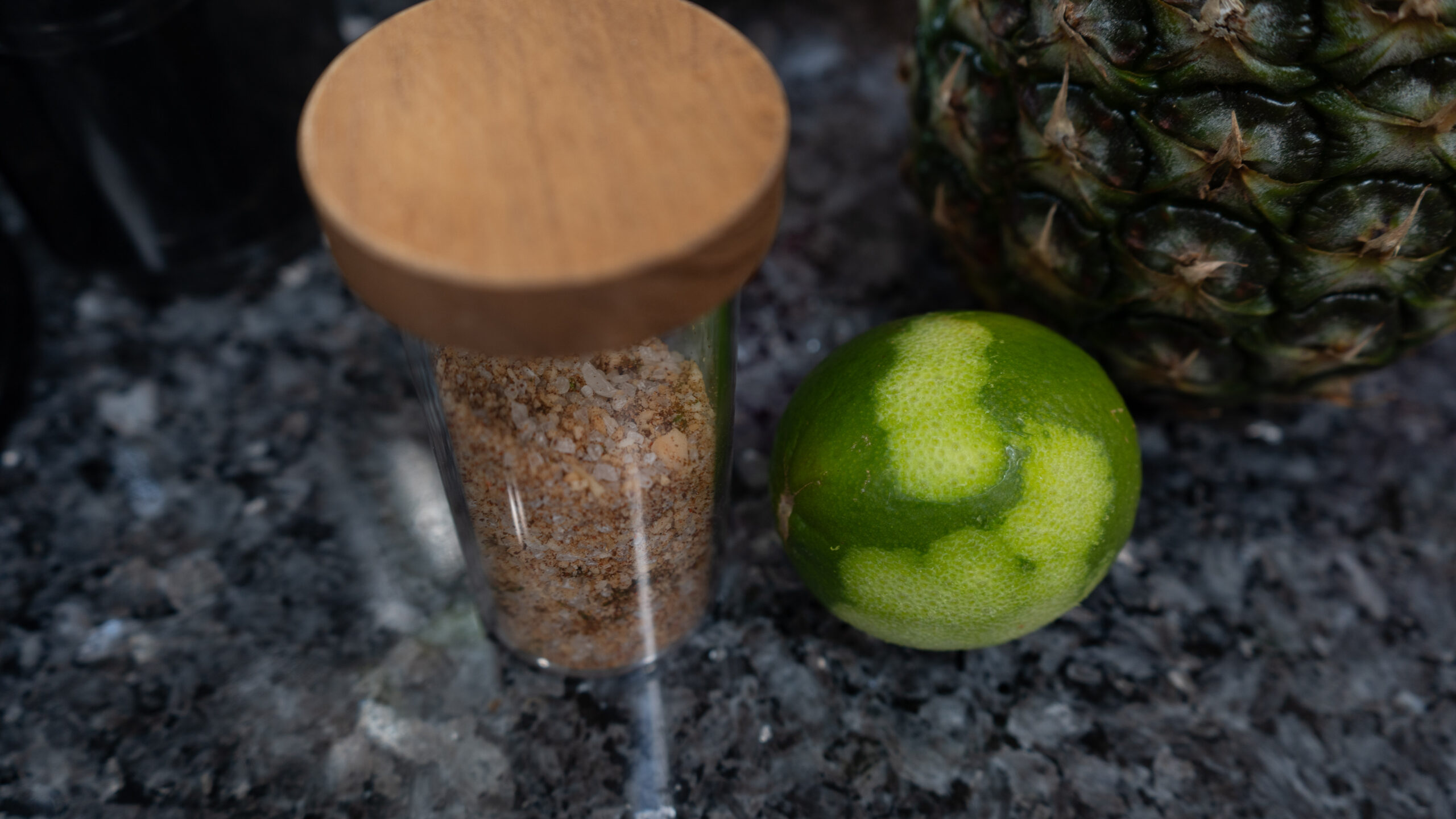 A jar of salt next to a lime