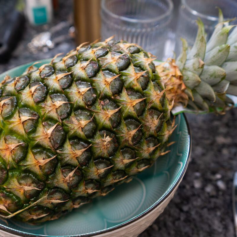 A large pineapple in a blue bowl