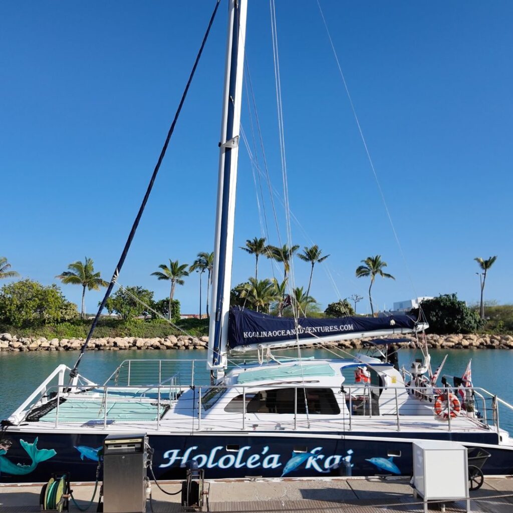 A sailboat with people on it that says Holole’a Kai