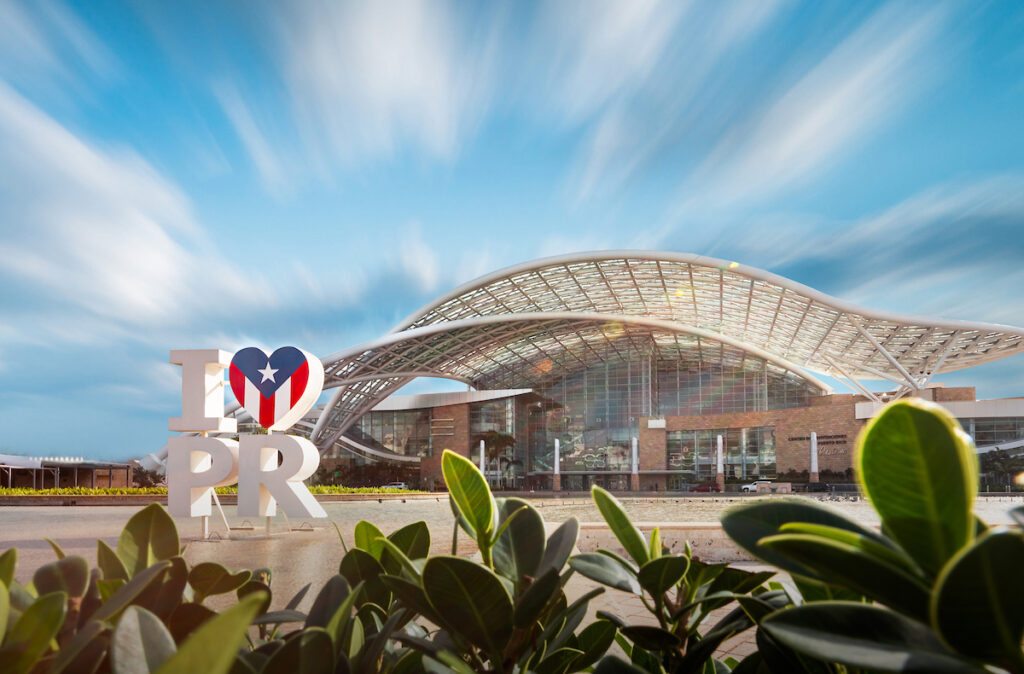 A modern building with a circular roof and an I love Puerto Rico sign in front of it.